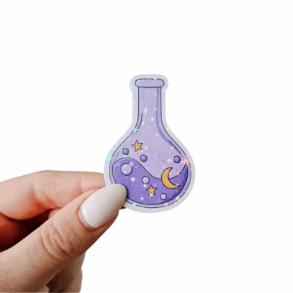 Hand holding a purple moon and stars holo sticker shaped like a potion bottle, with gold crescent moon, yellow stars, and holographic sparkle. Hand-illustrated fantasy sticker for journals, scrapbooking, and laptop decoration.