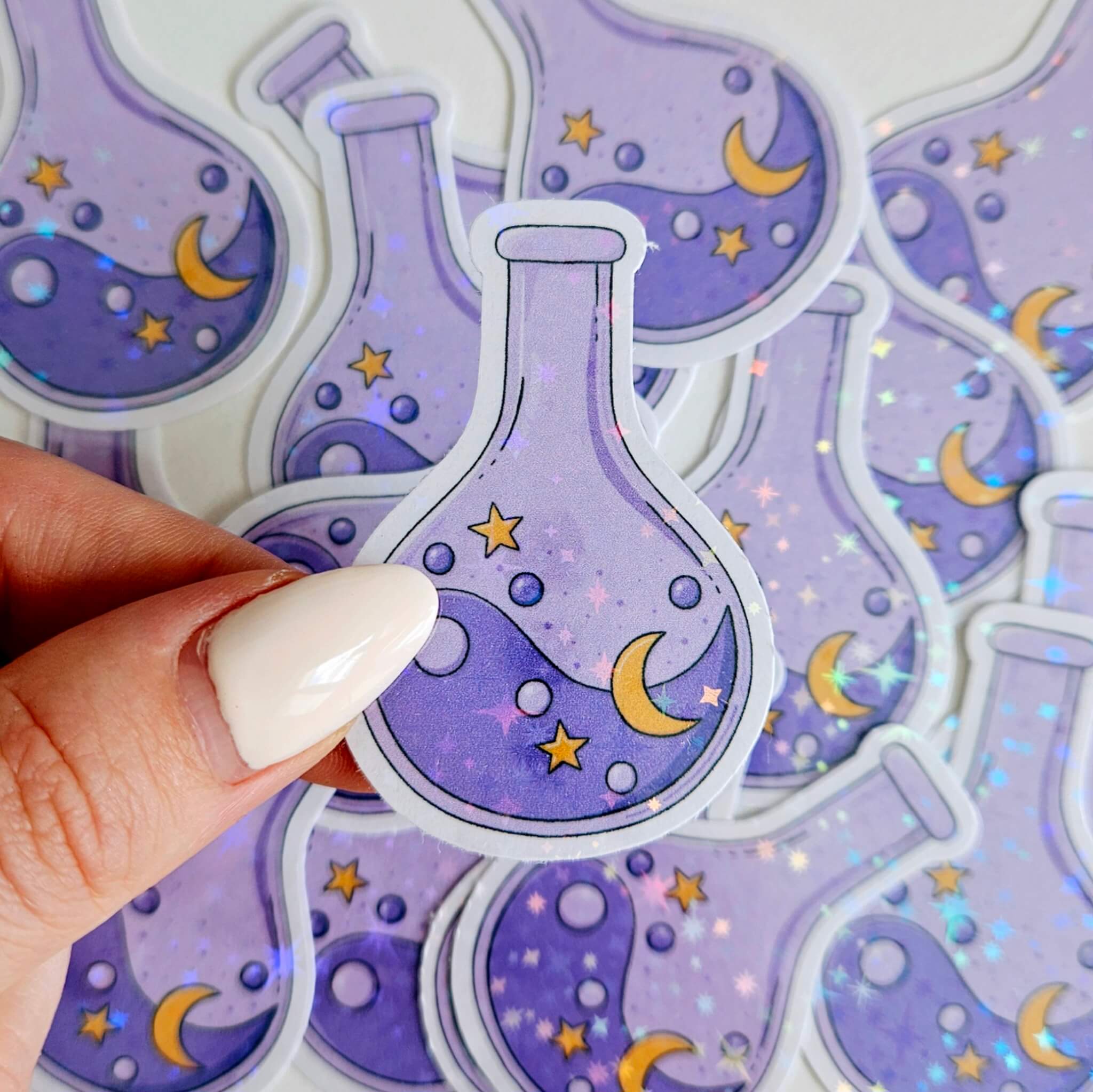 Holographic moon and stars potion bottle sticker in dreamy purple tones, celestial witchy aesthetic vinyl decal for journals, laptops, and water bottles.