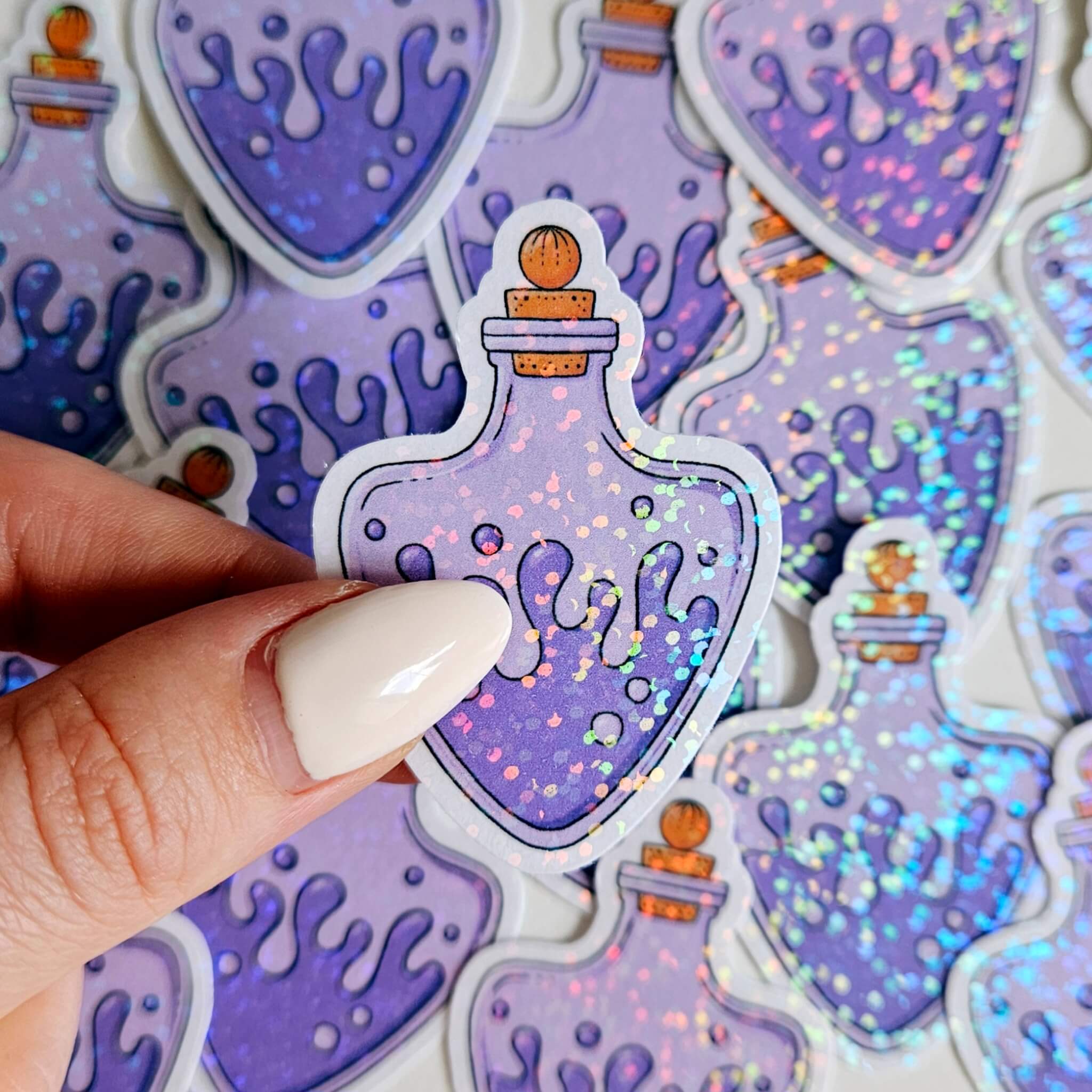 Iridescent holographic magic potion bottle sticker in purple with cork top, fantasy witchy vinyl decal for water bottles, laptops, and crafts.