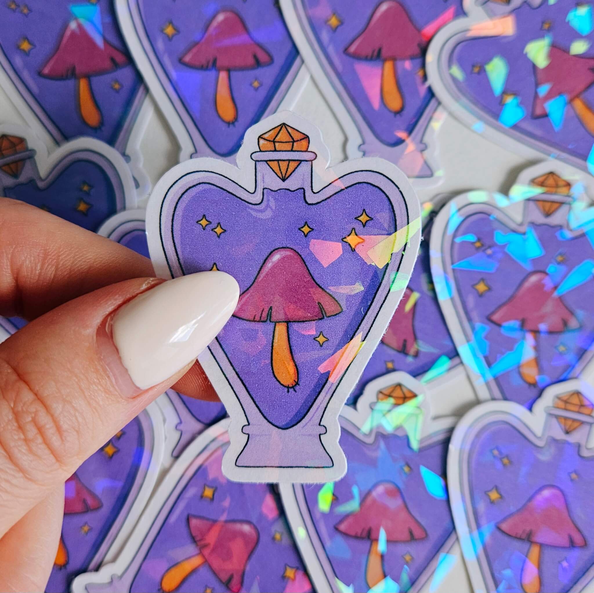 Purple holographic potion bottle sticker with pink mushroom and stars, whimsical witchy fantasy vinyl decal for laptops and water bottles.