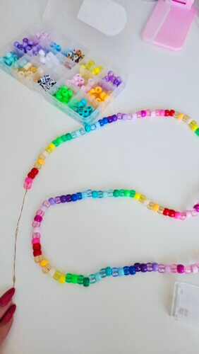 Work in progress picture putting beads onto string lights