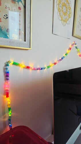 Finished string lights with pony beads above the workspace